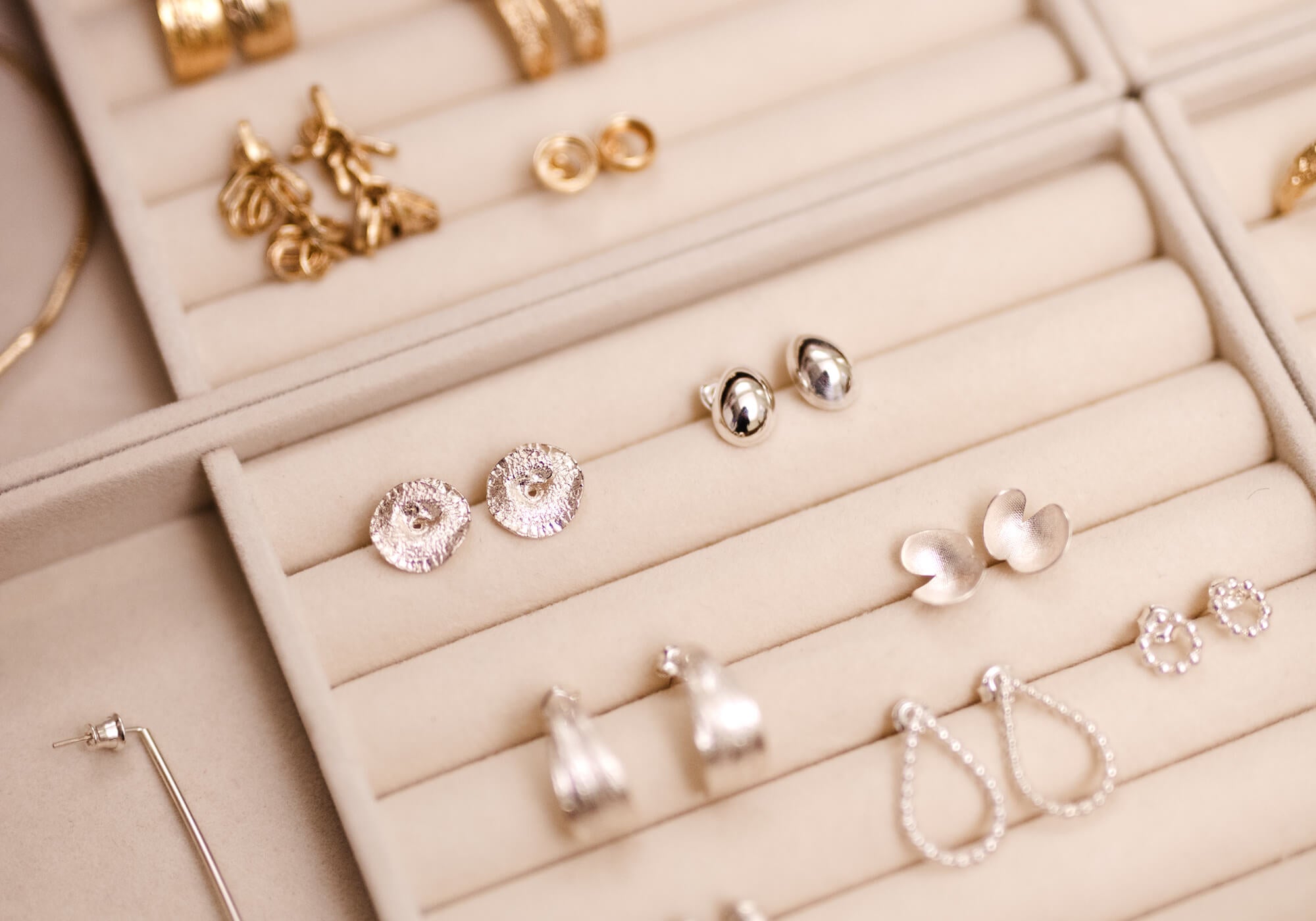 Collection of earrings displayed in an open jewelry box